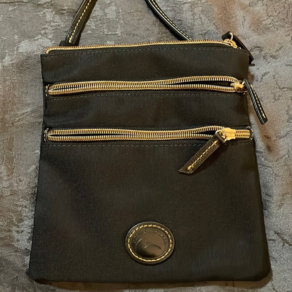 Dooney and Bourke black crossbody with two outside zipper pockets